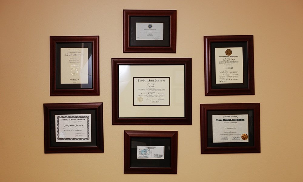 Dentists diplomas and certifications on wall